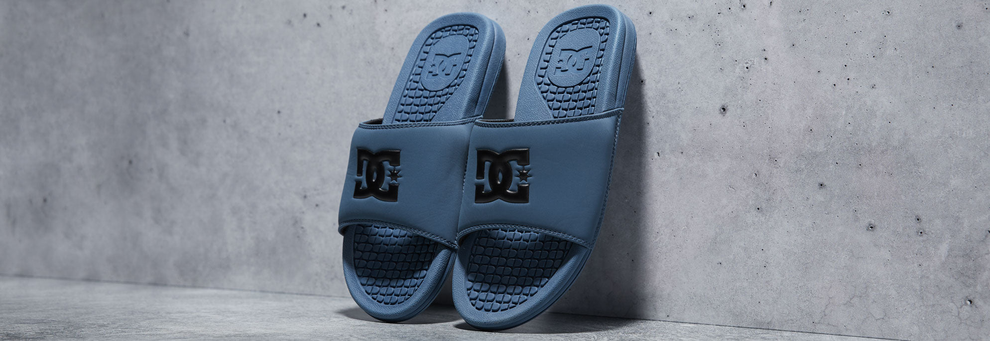 Teal slides propped up on a wall