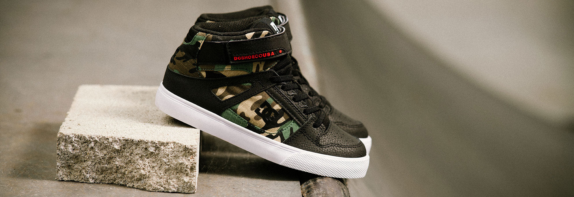 A pair of kids' shoes with camouflage design