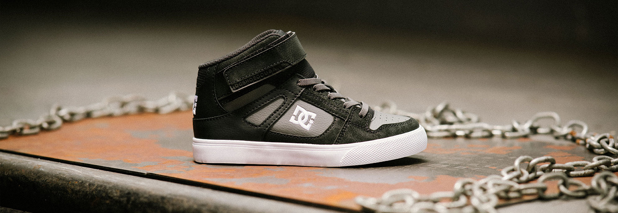 Pair of kids' shoes with a chain in the photo