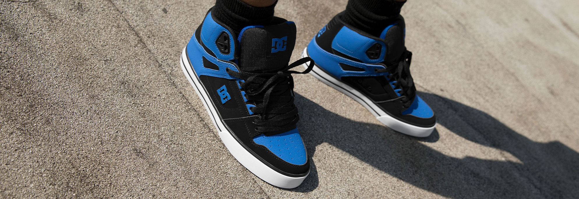 A pair of men's sneakers in black and blue