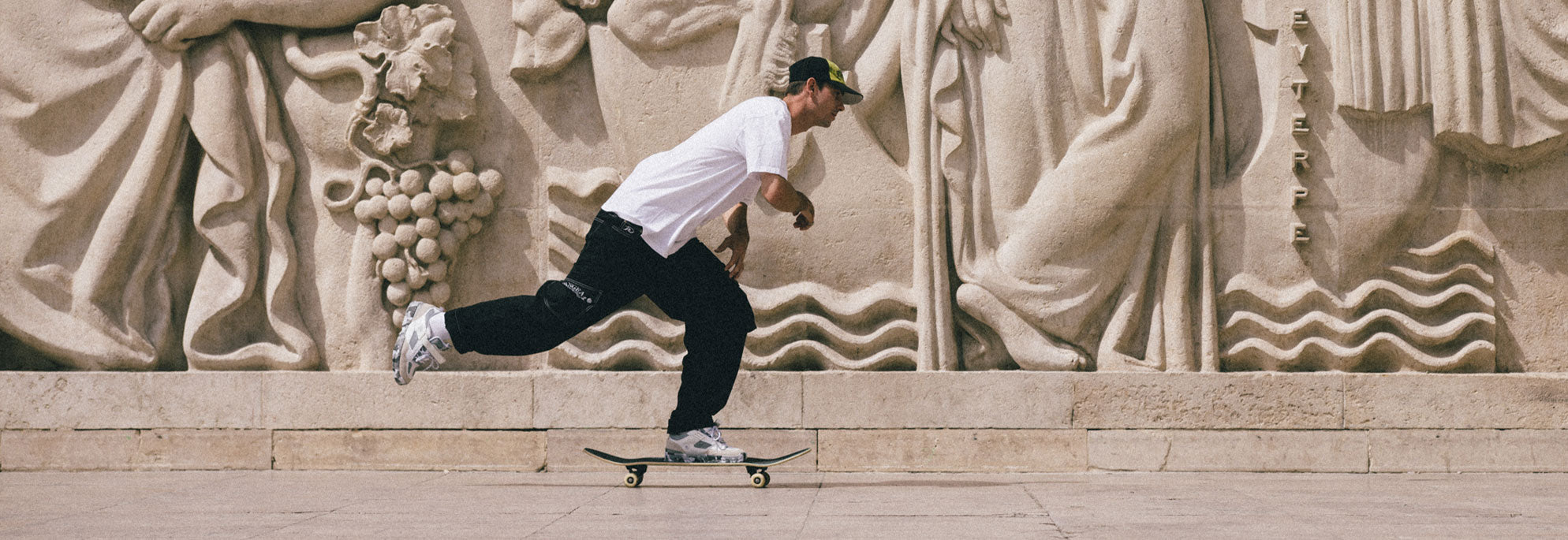 A man skateboarding with his leg in the air behind him