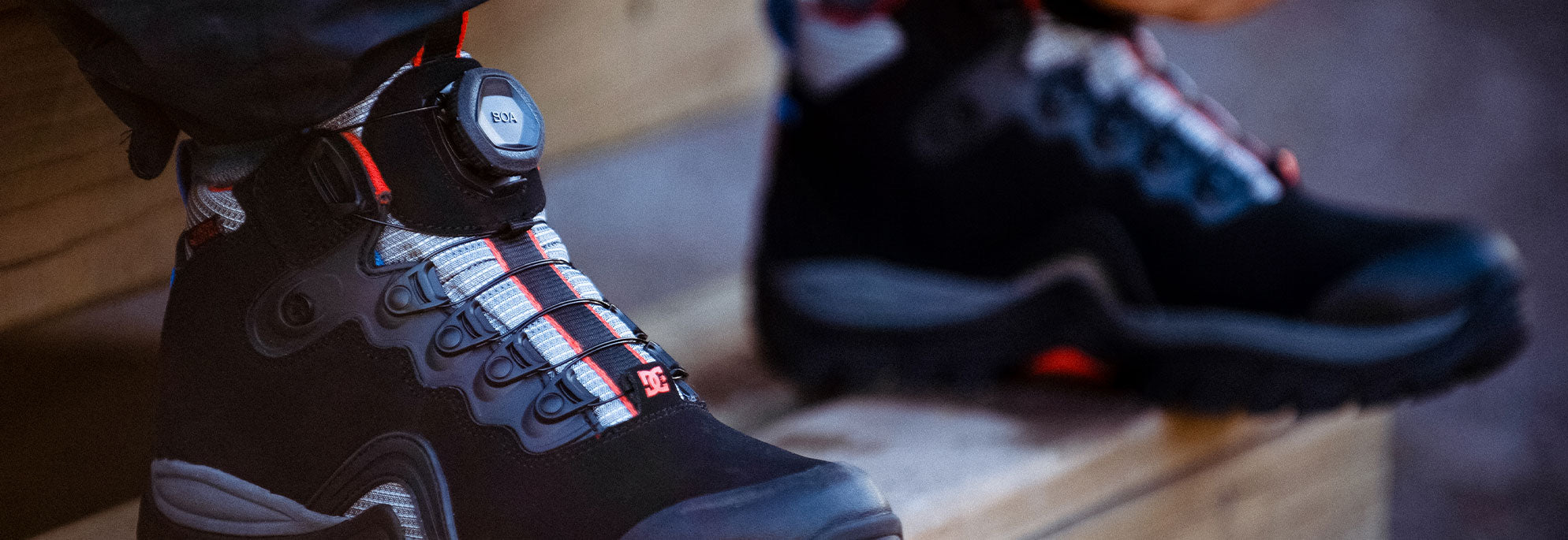 A pair of men's black winter boots on stairs