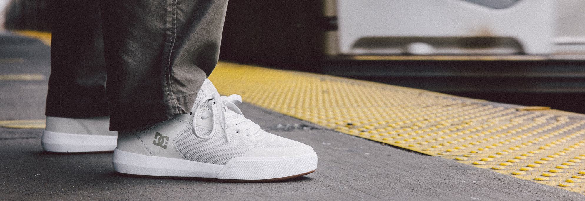 Men's Transit shoes worn by someone on a subway platform