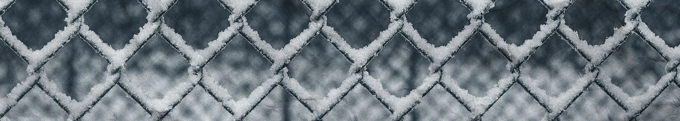 A fence with snow on it to symbolize a wintery theme