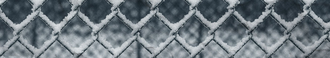 A fence with snow on it to symbolize a wintery theme