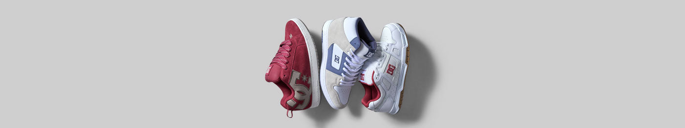 Three sneakers are displayed side by side on a light gray background: one red, one white with blue accents, and one white with red accents.