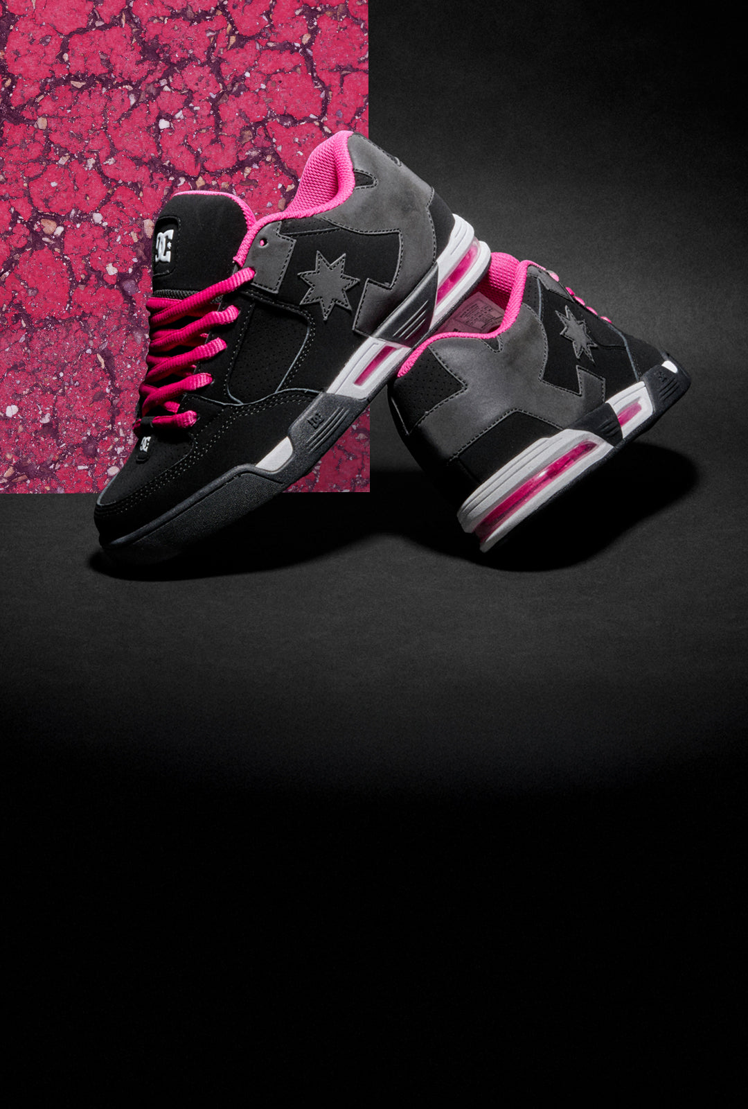 Black and pink sneakers with star design on a black background