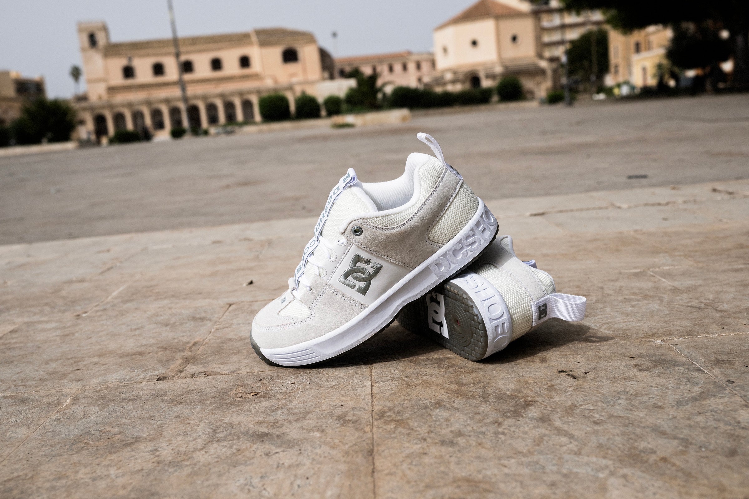 Heritage shoes in white and grey with a city background