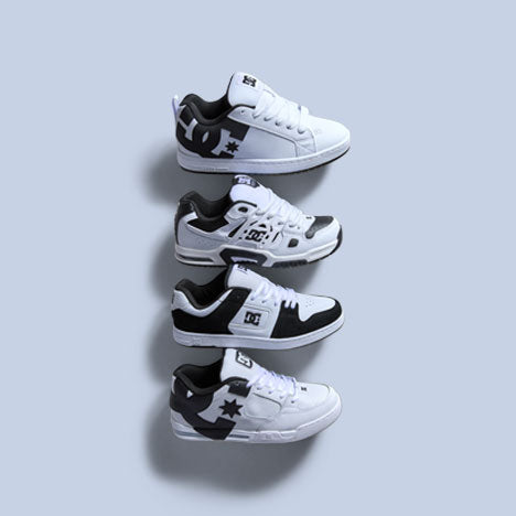 Four pairs of black and white sneakers arranged in a staggered formation on a light gray background.