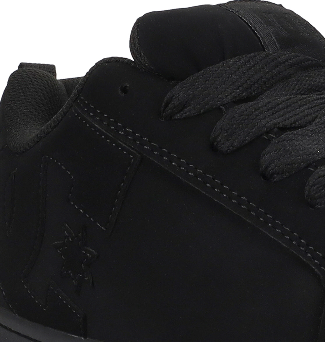 Close-up of a black sneaker with visible branding on a white background