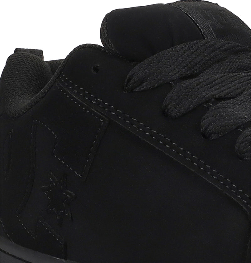 Close-up of a black sneaker with visible branding on a white background