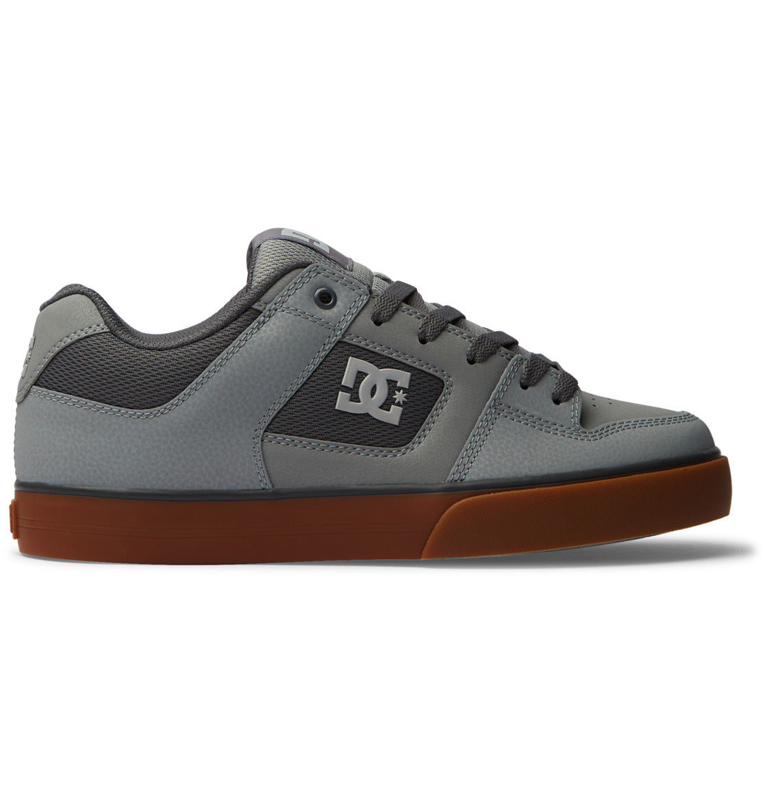 The DC Shoes Men’s Pure Shoes are shown in a left-side profile on a plain white background, featuring a gray design with dark gray laces, a white brand logo on the side, and a brown rubber sole—comfortable and versatile men’s shoes ideal for everyday wear.