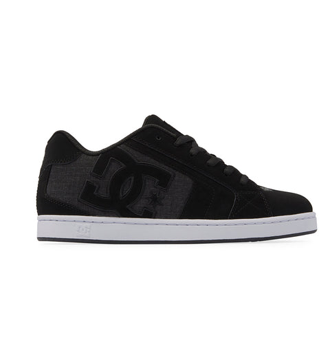 The Men's Net Shoes by DC Shoes feature a black design with a white sole, large DC logo on the side, black laces, and are made from durable fabrics for long-lasting wear.