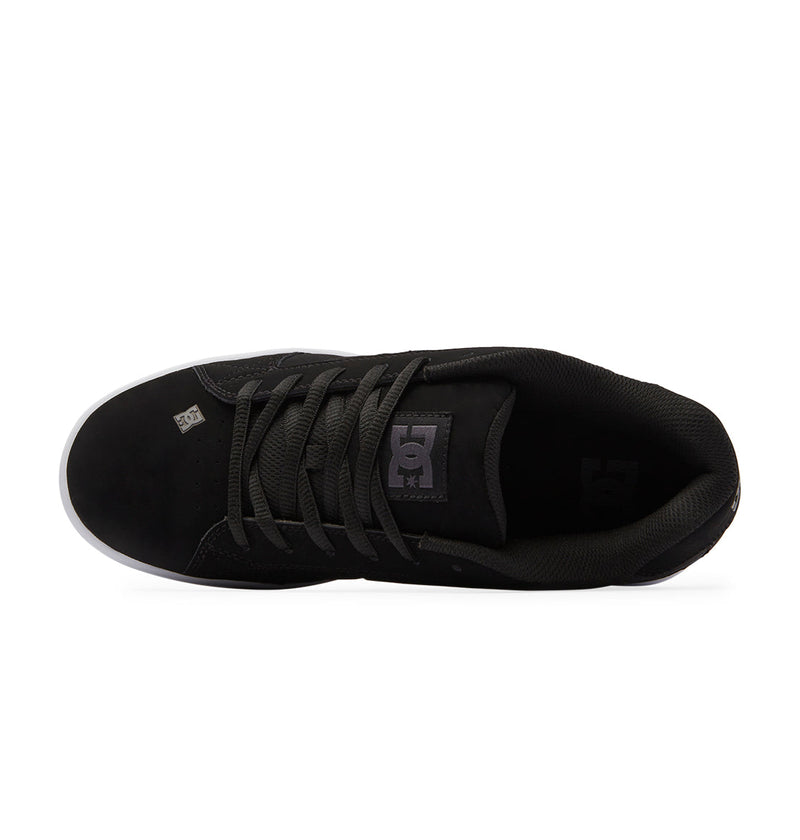 The Men's Net Shoes by DC Shoes are black puffy sneakers seen from above, with black laces, a padded collar, and DC Shoes logos on the tongue and insole. Built from durable fabrics, they have a white outsole for lasting wear.