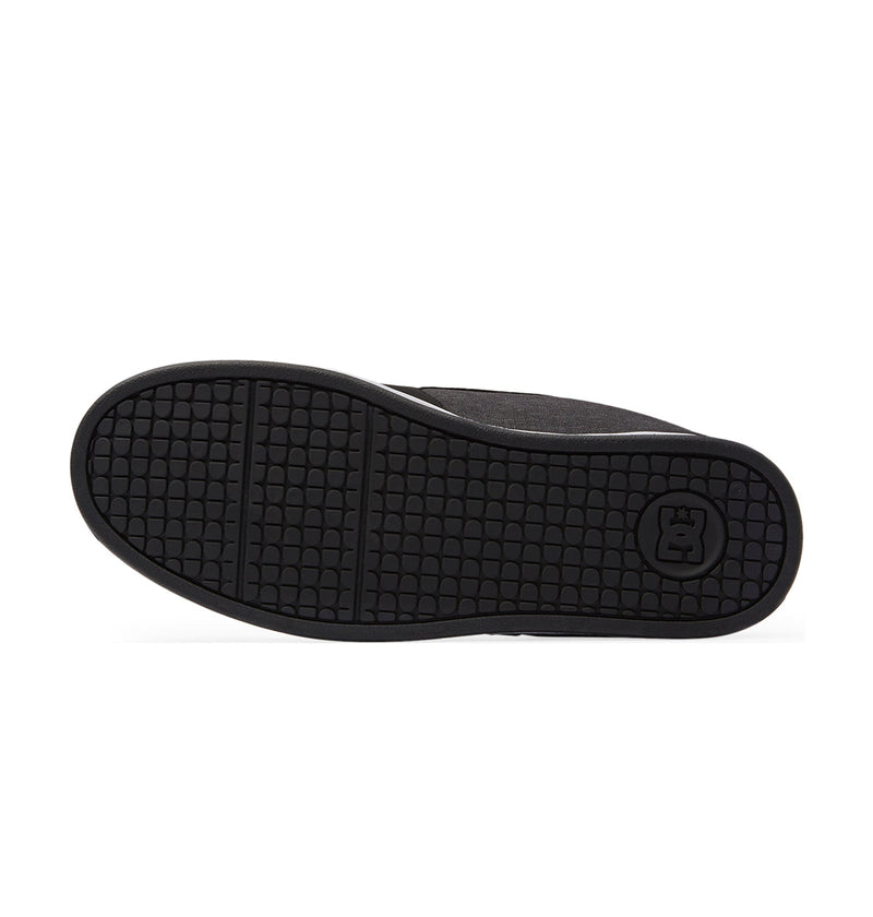 The Men's Net Shoes by DC Shoes feature a black rubber sole with a textured square-patterned tread and a small circular crown logo near the heel.