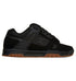 The DC Shoes Men’s Stag Shoes are shown in side view against a white background, featuring a black low-profile design with mesh and suede uppers, black laces, perforated panels, and a durable brown cupsole.