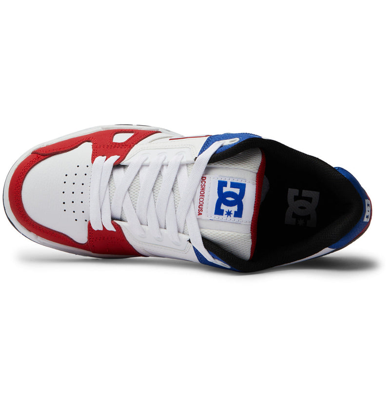 A top view of the DC Shoes Men's Stag Shoes highlights a white toe and laces, red overlays, blue heel accents, black interior lining, an oversized puff tongue with the DC logo, and a durable cupsole for lasting comfort.