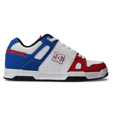 The Men's Stag Shoes by DC Shoes feature white, blue, and red panels, white laces, an oversized puff tongue, a durable cupsole, and the signature DC logo on the side.
