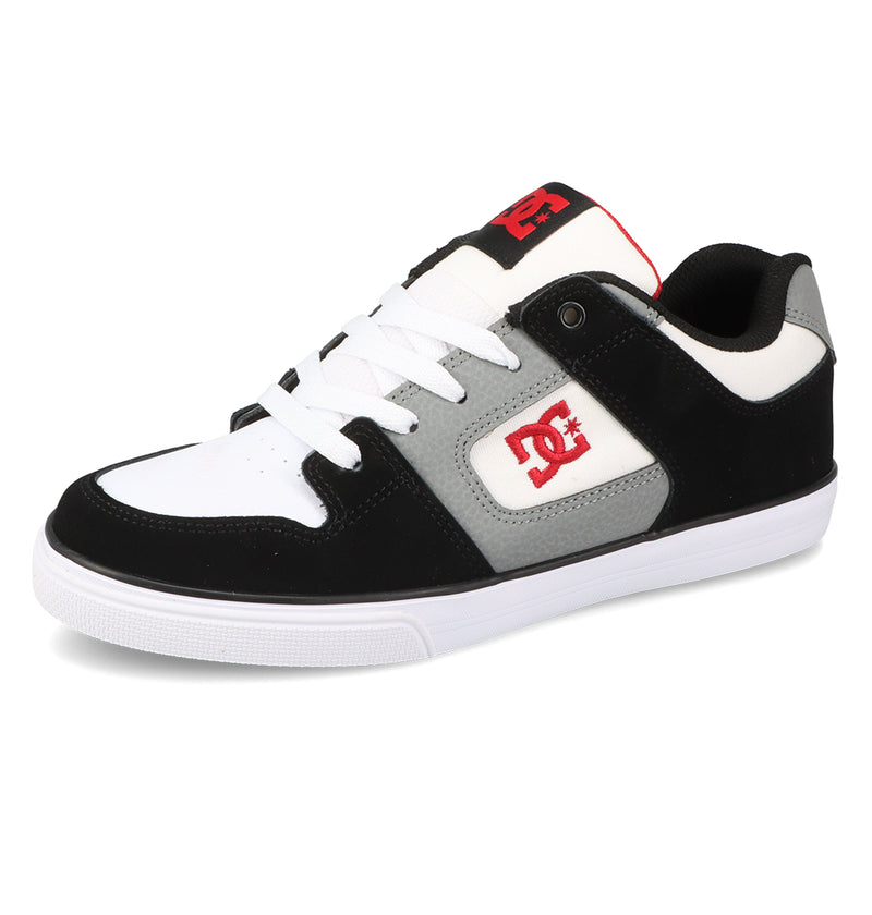 The Kids’ Pure Shoes by DC Shoes are black, white, and gray skate shoes featuring white laces, a red DC logo, and a red trim on the tongue. Shown angled to highlight the side and top, these shoes showcase their durable construction crafted for comfort and everyday wear.