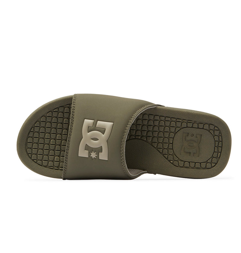 The DC Shoes Men's Bolsa Slides in olive green feature a textured sole and wide strap with a bold embossed logo, offering perfect comfort for any skate session.