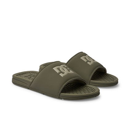 The DC Shoes Men's Bolsa Slides in olive green feature textured footbeds and wide straps with a lighter DC logo—ideal for comfort after a skate session.