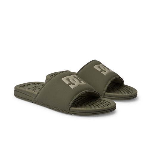 The DC Shoes Men's Bolsa Slides in olive green feature textured footbeds and wide straps with a lighter DC logo—ideal for comfort after a skate session.