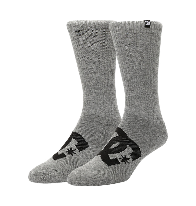 A pair of gray DC Shoes Logo Crew Socks from the 6-Pack, featuring a black DC logo on the sides and a small black tag with a white DC logo at the cuff, stands upright against a plain white background.