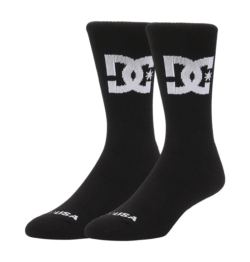A pair from the DC Shoes Big Star Logo Crew Socks 3-Pack features a black design with a large white DC Shoes logo on the calves and "USA" text in white near the toes.
