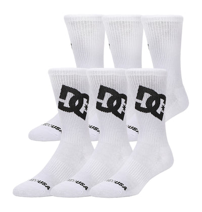 The DC Shoes Graffik Logo Crew Socks 3-Pack includes three pairs of white crew socks featuring the large black DC Shoes logo on the sides and "DC USA" in black near the toes, shown arranged against a white background.