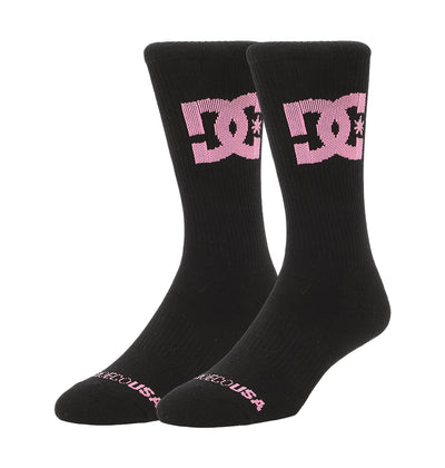 The DC Shoes Big Star Logo Crew Socks 3-Pack includes black crew socks with a large pink DC logo on the sides and "DELICIOUS" in pink near the toes.