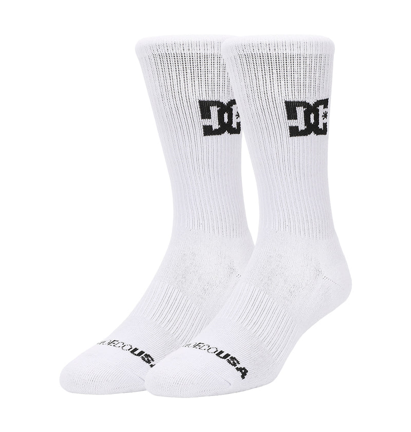 DC Shoes Crew Socks 6-Pack in white with black DC Shoes logo on the ankles and "DC SHOES USA" text on the toes, displayed standing upright on a plain white background.