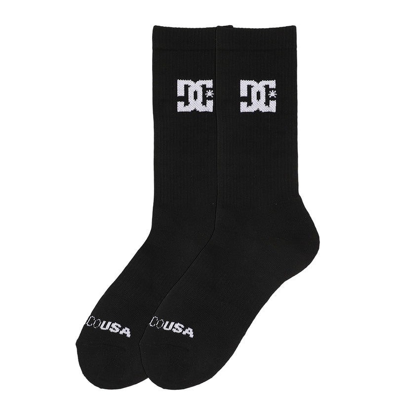 The Crew Socks 6-Pack by DC Shoes includes black crew socks with a white "DC" logo near the top and "DC USA" text in white on the toes.
