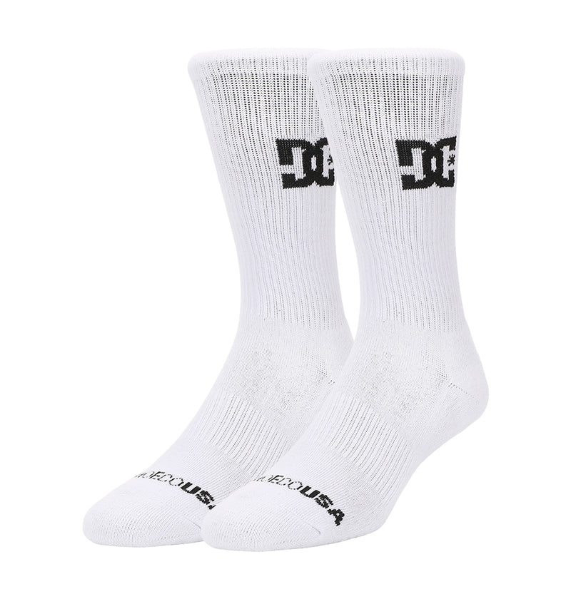The DC Shoes Crew Socks 6-Pack features white crew socks with a black DC Shoes logo near the top and "DC SHOES USA" in black on the toes, all displayed upright against a plain white background.