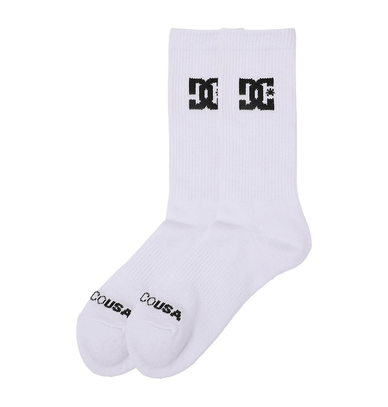 The DC Shoes Crew Socks 6-Pack features white crew socks with a black DC Shoes logo on the front and "COUSA" printed near the toes, shown side by side on a plain white background.