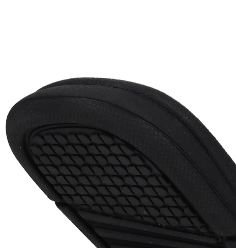 Close-up of the sole on DC Shoes Kids' Bolsa Slides, featuring a black diamond-patterned grip—offering secure comfort and standout style.