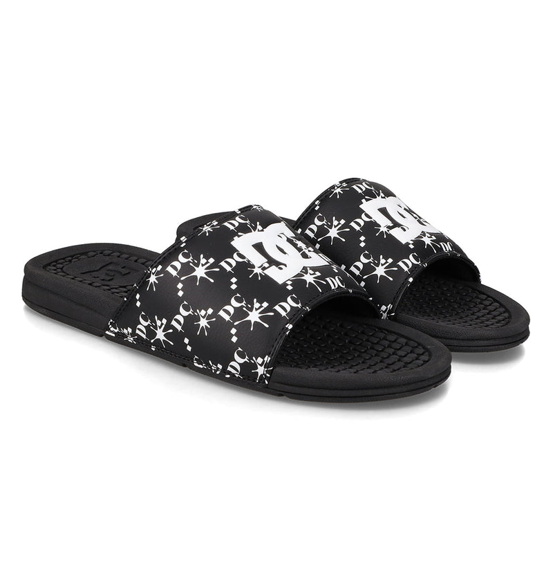 The Men's Bolsa Slides by DC Shoes feature black straps with white logos and decorative patterns, plus textured footbeds and open toes—ideal for your next skate session.