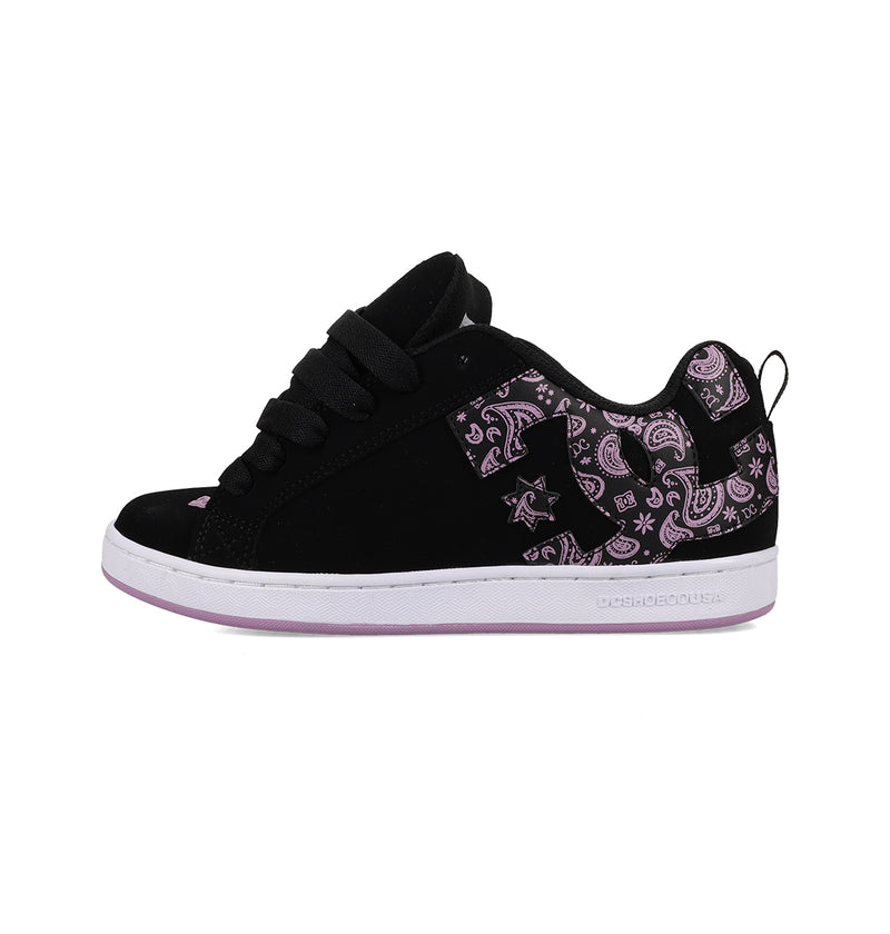 The Women's Court Graffik Shoes by DC Shoes are black low-top sneakers with black laces, a white sole, purple paisley patterns on the side and heel, a slight purple-tinted outsole, and a small star detail for '90s-inspired style.