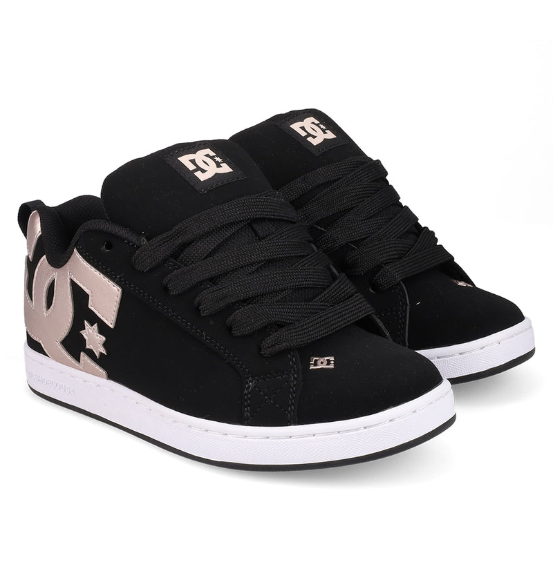A pair of DC Shoes Women's Court Graffik sneakers in black with a puffy silhouette, thick black laces, white soles, and large metallic gold DC logos on the sides and tongues, shown on a white background.
