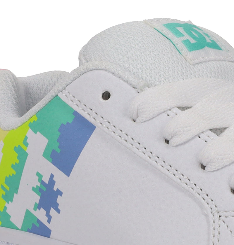 Close-up of DC Shoes Kids' Court Graffik Shoes—white sneakers with white laces, a colorful pixelated blue, green, and yellow side pattern, and a mesh-textured tongue featuring a teal DC logo.