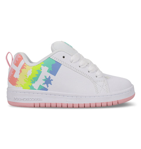 The Kids' Court Graffik Shoes by DC Shoes feature white uppers and laces, a pink sole, pixelated rainbow side graphics fading from yellow to green, blue, and pink, plus pink accents on the heel tab and outsole.