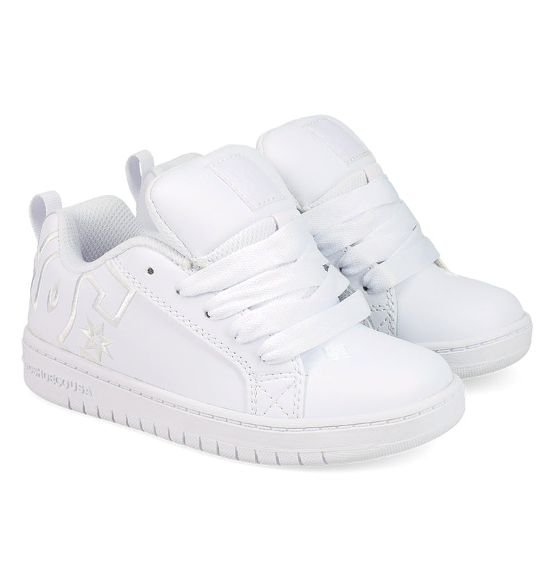 The DC Shoes Kids' Court Graffik Shoes are white low-top sneakers with thick white laces, a chunky sole, subtle embossed logo, and side stitching details, inspired by classic skate styles.