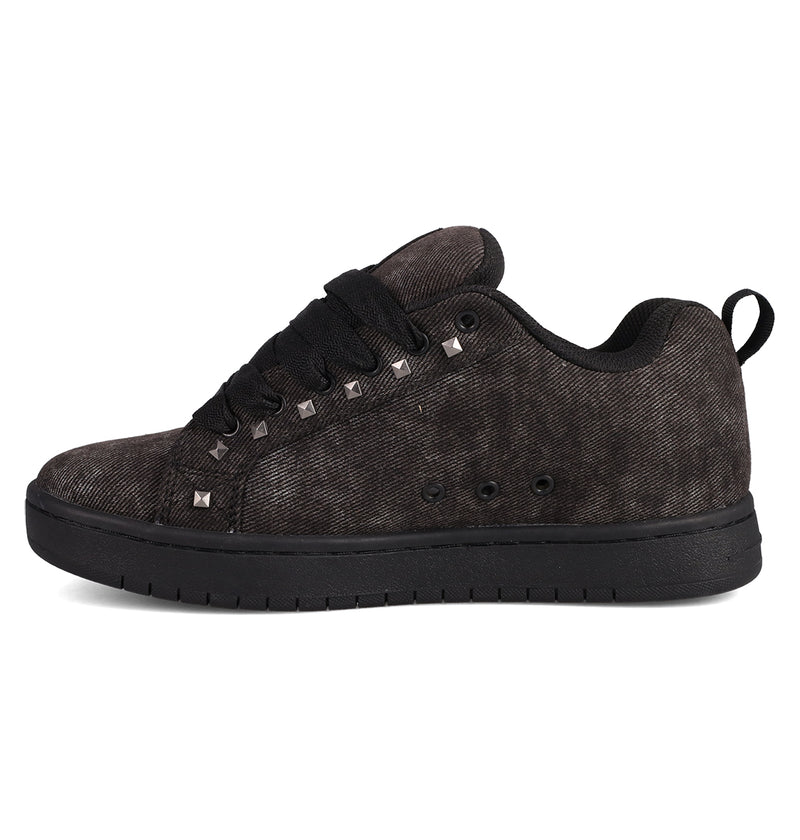The DC Shoes Men's Court Graffik SE Shoes is a black, low-top sneaker with a puffy silhouette, black laces, metallic square studs on the side, a heel loop, and textured sole, shown in side profile against a white background.