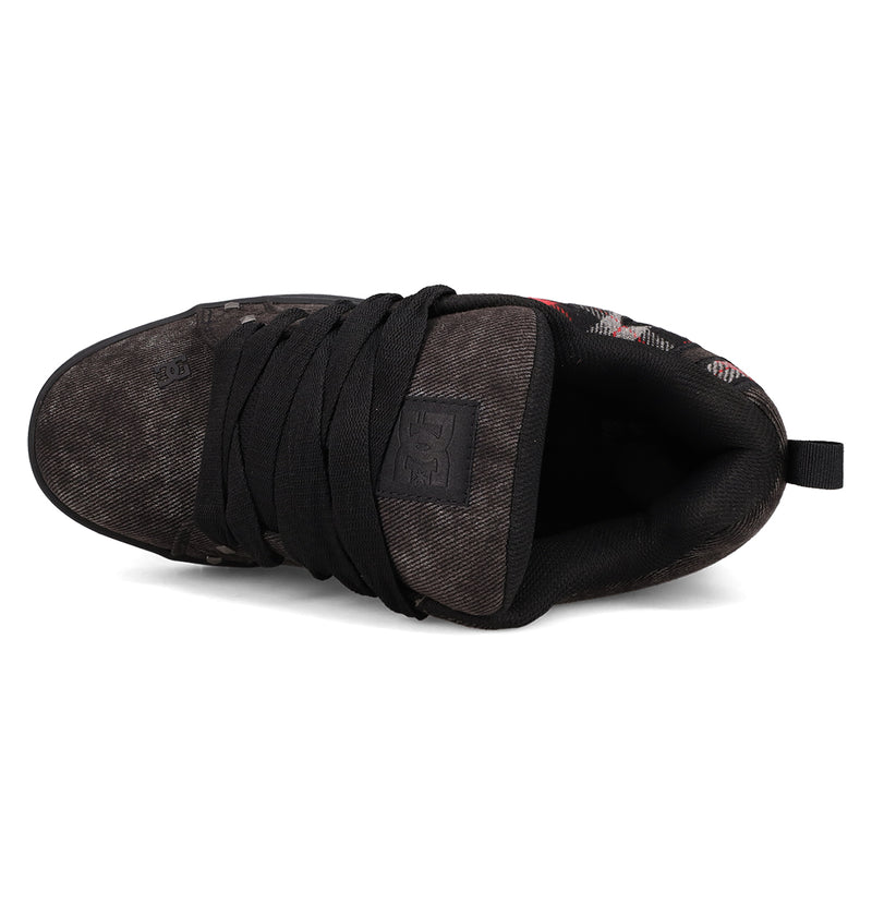 Top view of DC Shoes Men's Court Graffik SE Shoes in black, featuring a puffy silhouette, thick black laces, padded tongue with DC logo, and a worn textured finish on the premium material upper at the toe and sides.