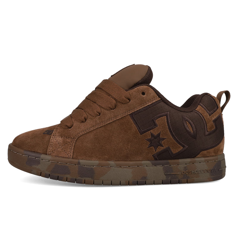 The DC Shoes Men's Court Graffik SE features brown suede, a puffy silhouette, dark brown accents, thick laces, a padded tongue, and a bold DC logo. Its sole showcases a trendy green and brown camouflage pattern.