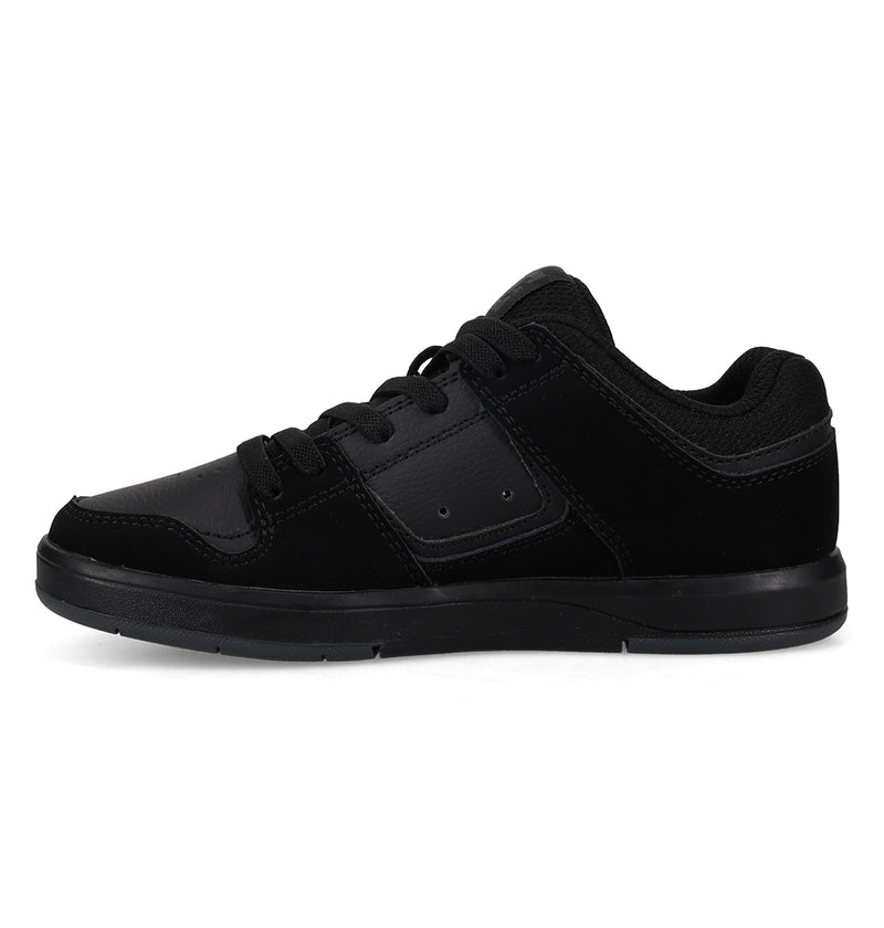 The Kids' DC Shoes Cure Elastic Shoes by DC Shoes are black low-top sneakers with a lace-up design, flat sole, and subtle stitching, displayed in side profile on a white background.