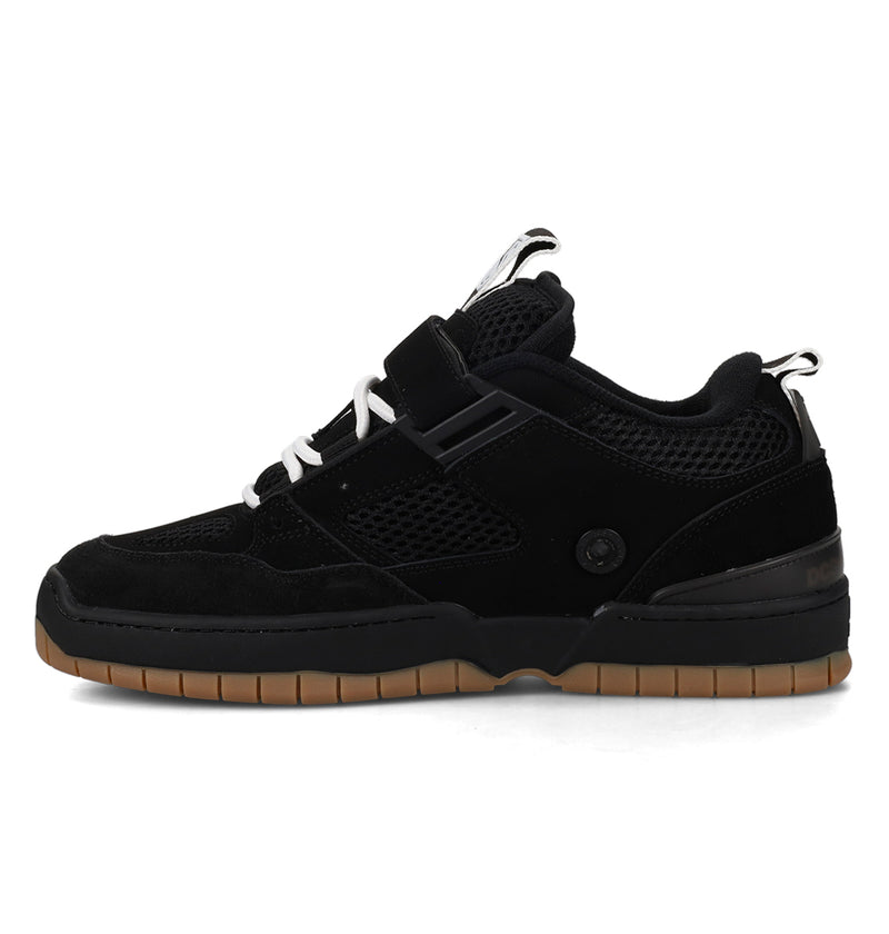 Black sneaker with brown sole on a white background