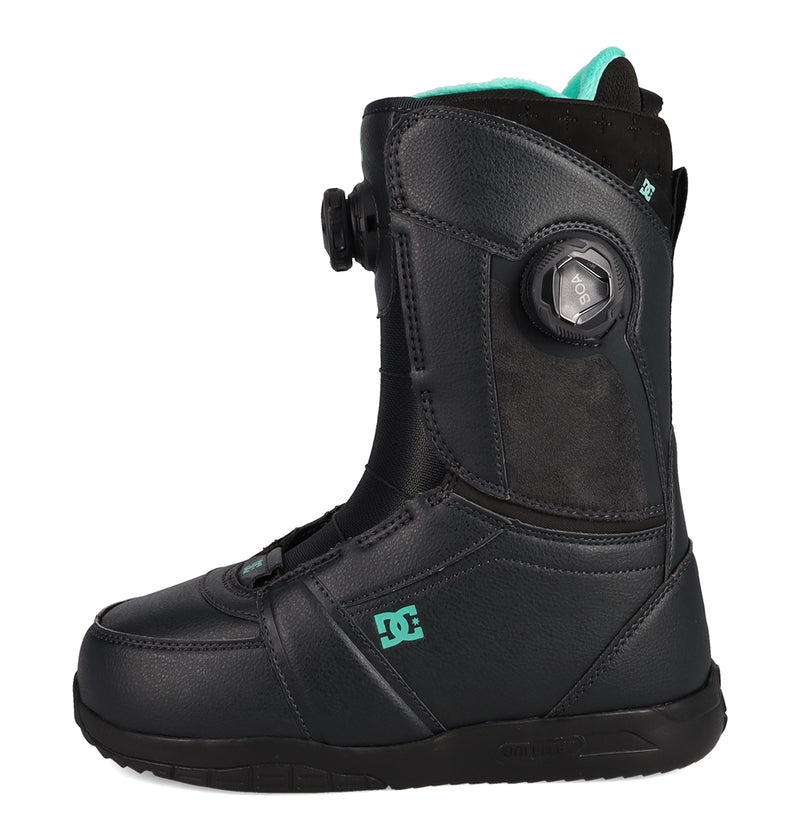 A side view of the DC Shoes Women's Lotus Dk Snowboard Boots in black with turquoise accents, featuring a Boa dial closure system and a durable Unilite outsole for lightweight support and cushioning, displayed against a white background.