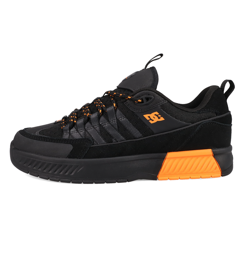 Black and orange sneaker with a brand logo on a white background