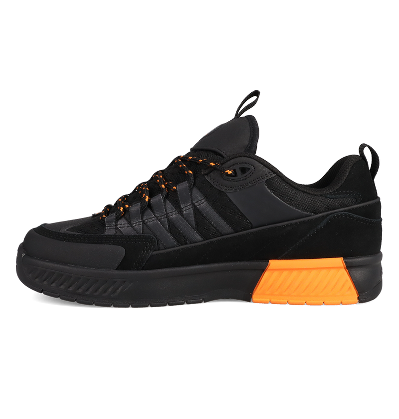 Black sneaker with orange sole on a white background