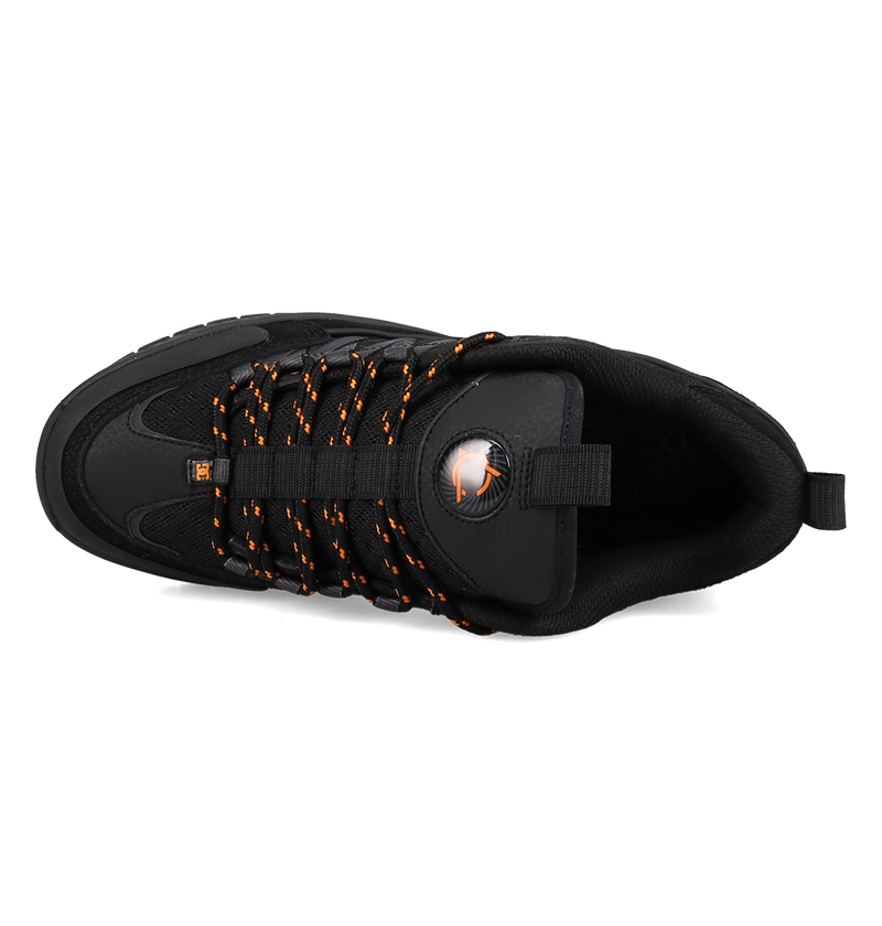 Black sneaker with orange accents on a white background